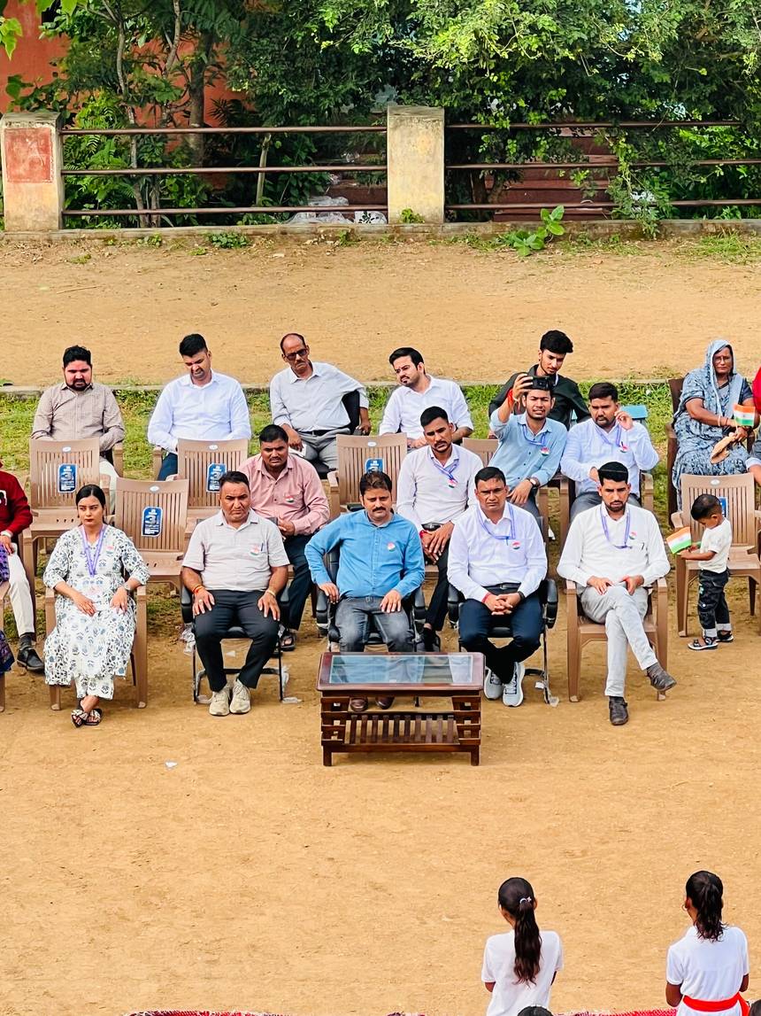 Guests seated on the assembly ground during a school function